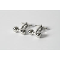 Silver dumbbell-shaped cufflinks on a white background