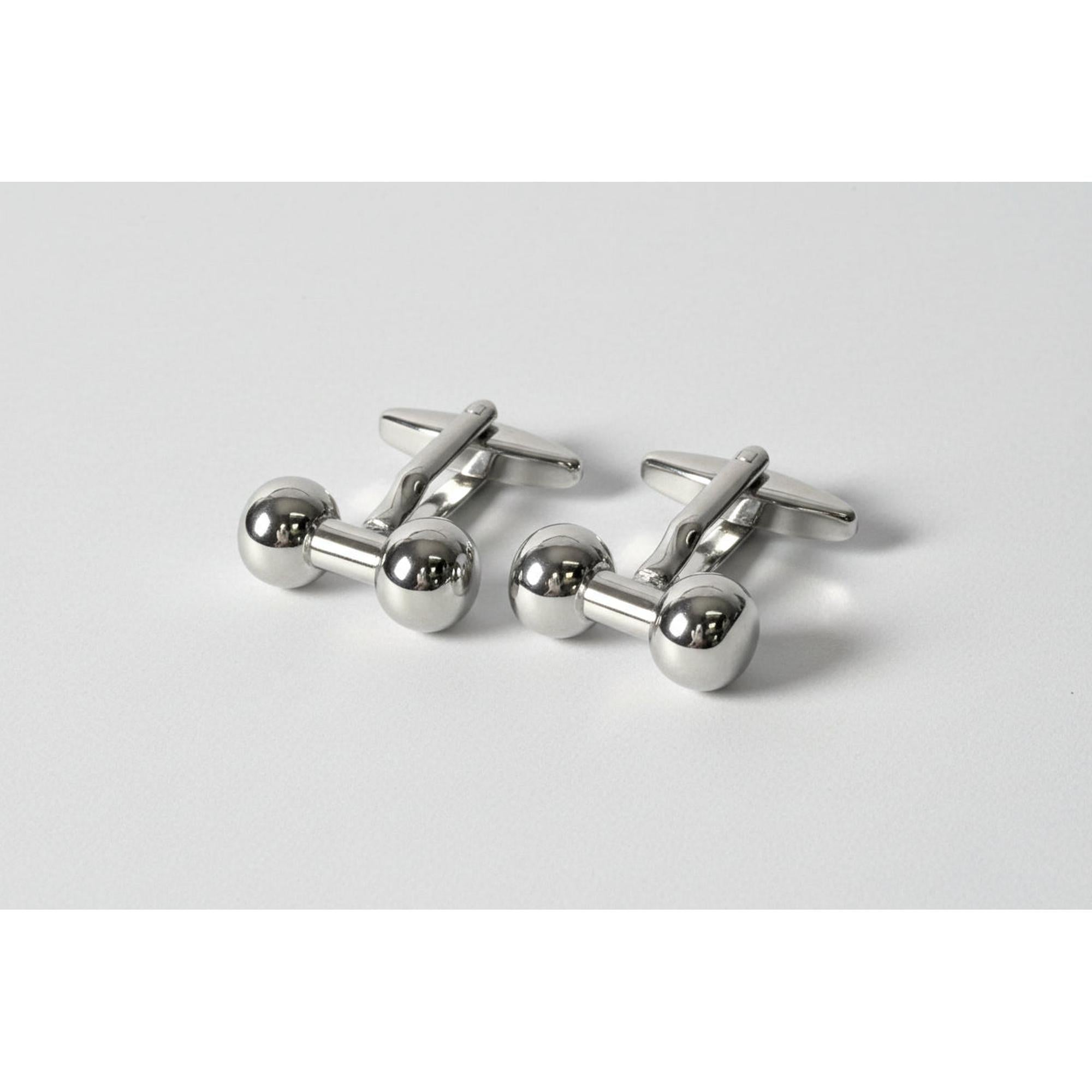 Silver dumbbell-shaped cufflinks on a white background