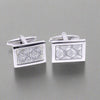 Pair of silver rectangular cufflinks with textured design on a white background