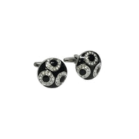 Black and silver cufflinks with circular design on a white background