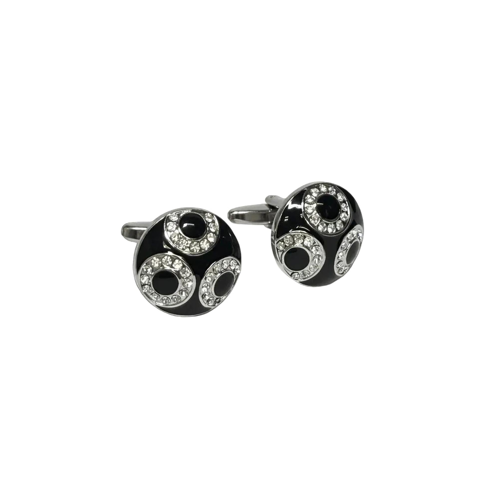 Black and silver cufflinks with circular design on a white background