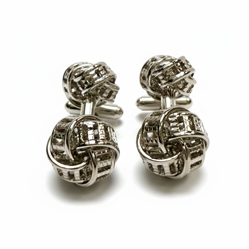 Silver knot cufflinks on a white background
