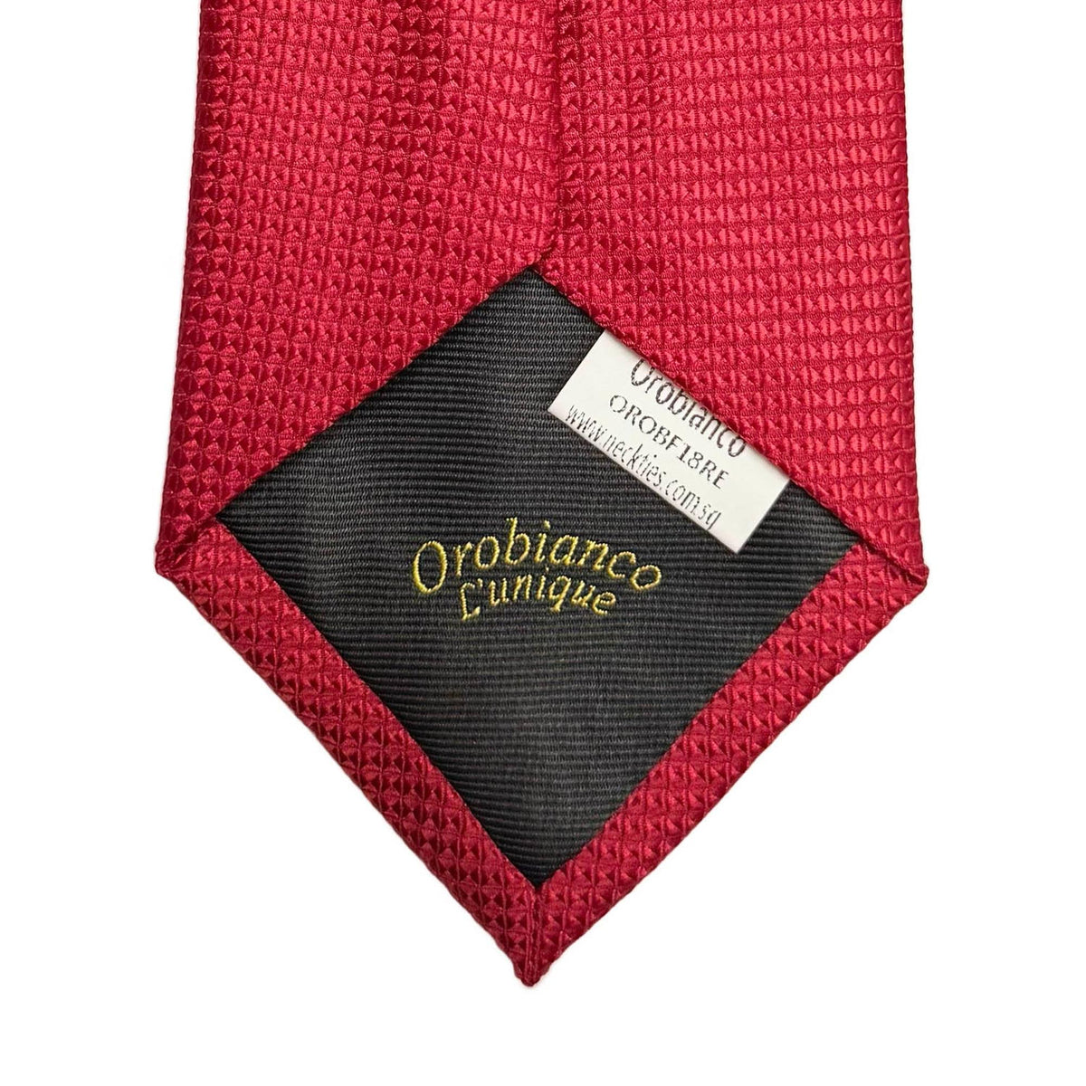 Red textured tie with a visible brand label on a white background