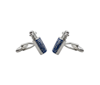 A pair of silver-toned cufflinks with rectangular blue enamel panels featuring white decorative patterns, displayed on a light gray background.