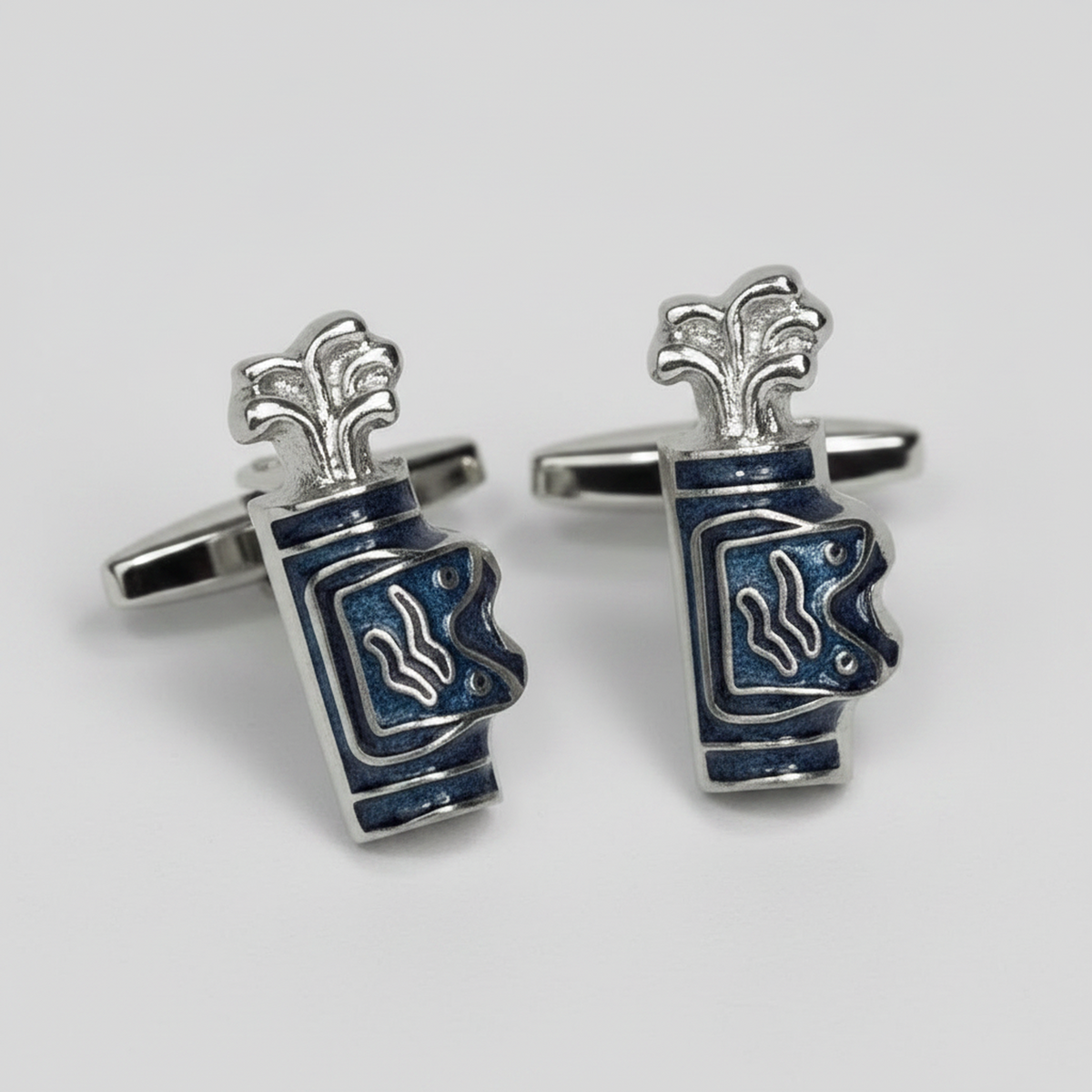 A pair of Golf silver cufflinks shaped like stacked blue and white enamel cups, photographed on a light gray background.