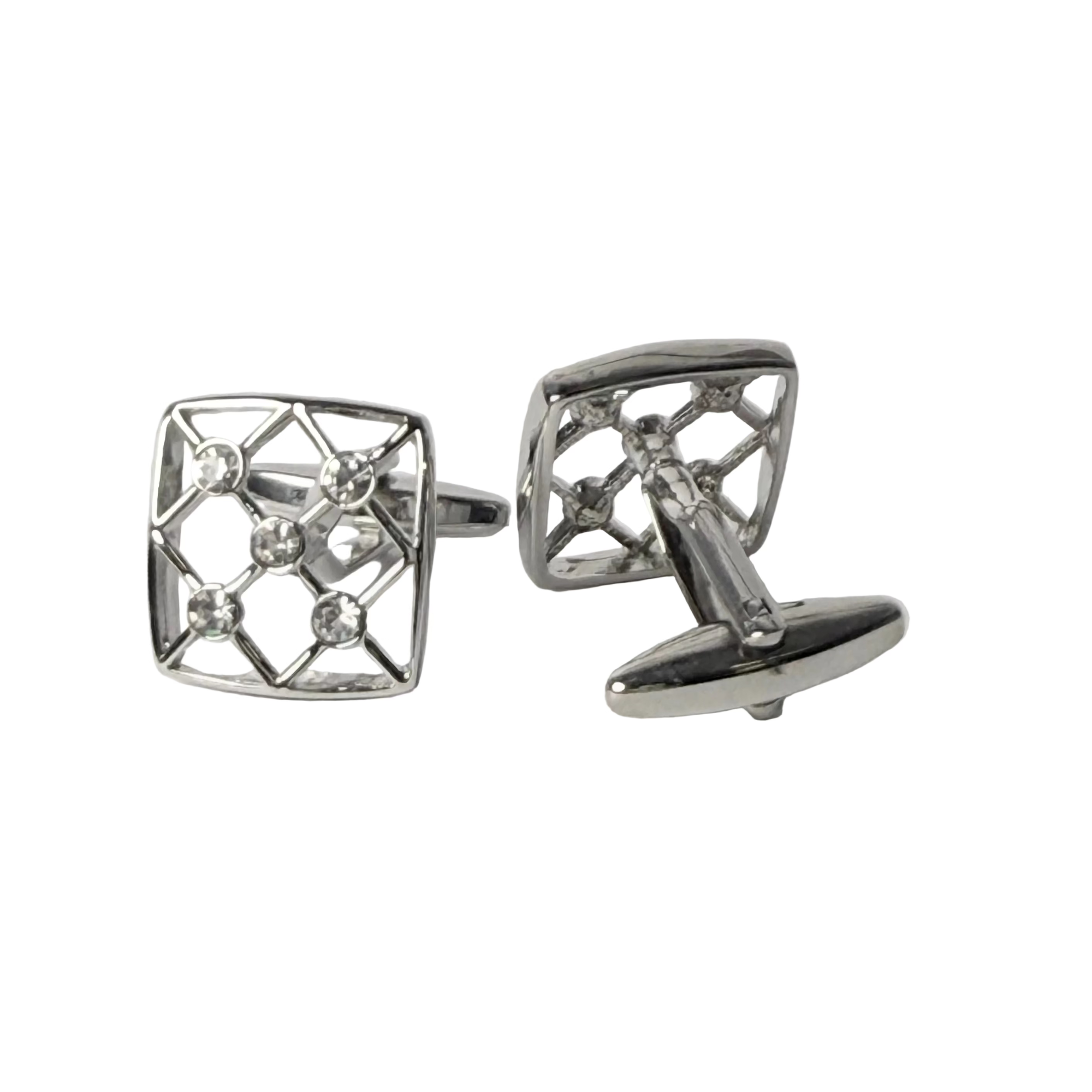 Pair of silver cufflinks with geometric design on a light gray background