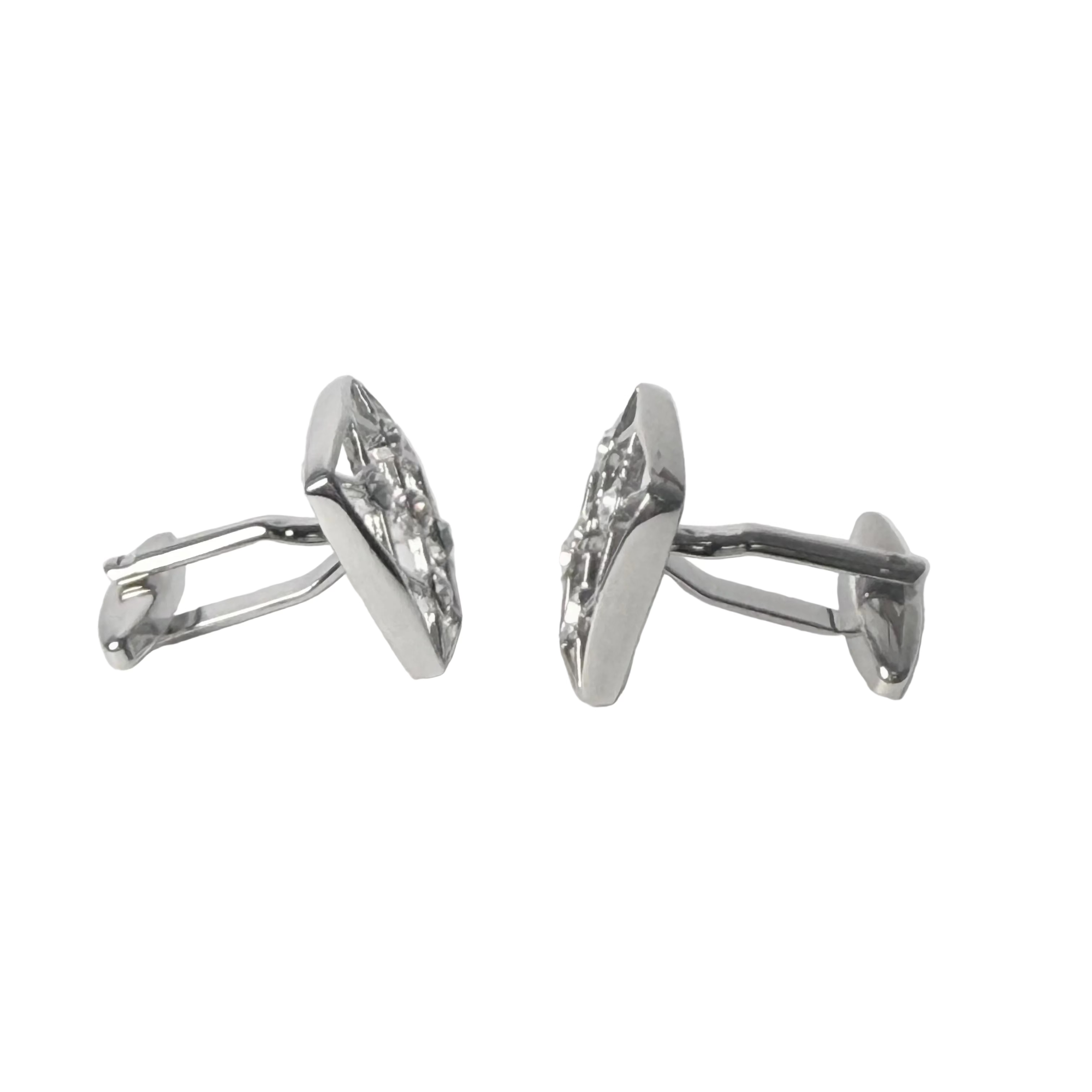 Pair of silver earrings on a light gray background