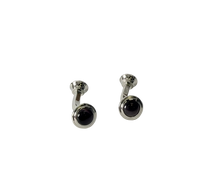 A pair of silver-toned cufflinks with round Brown fiberglass