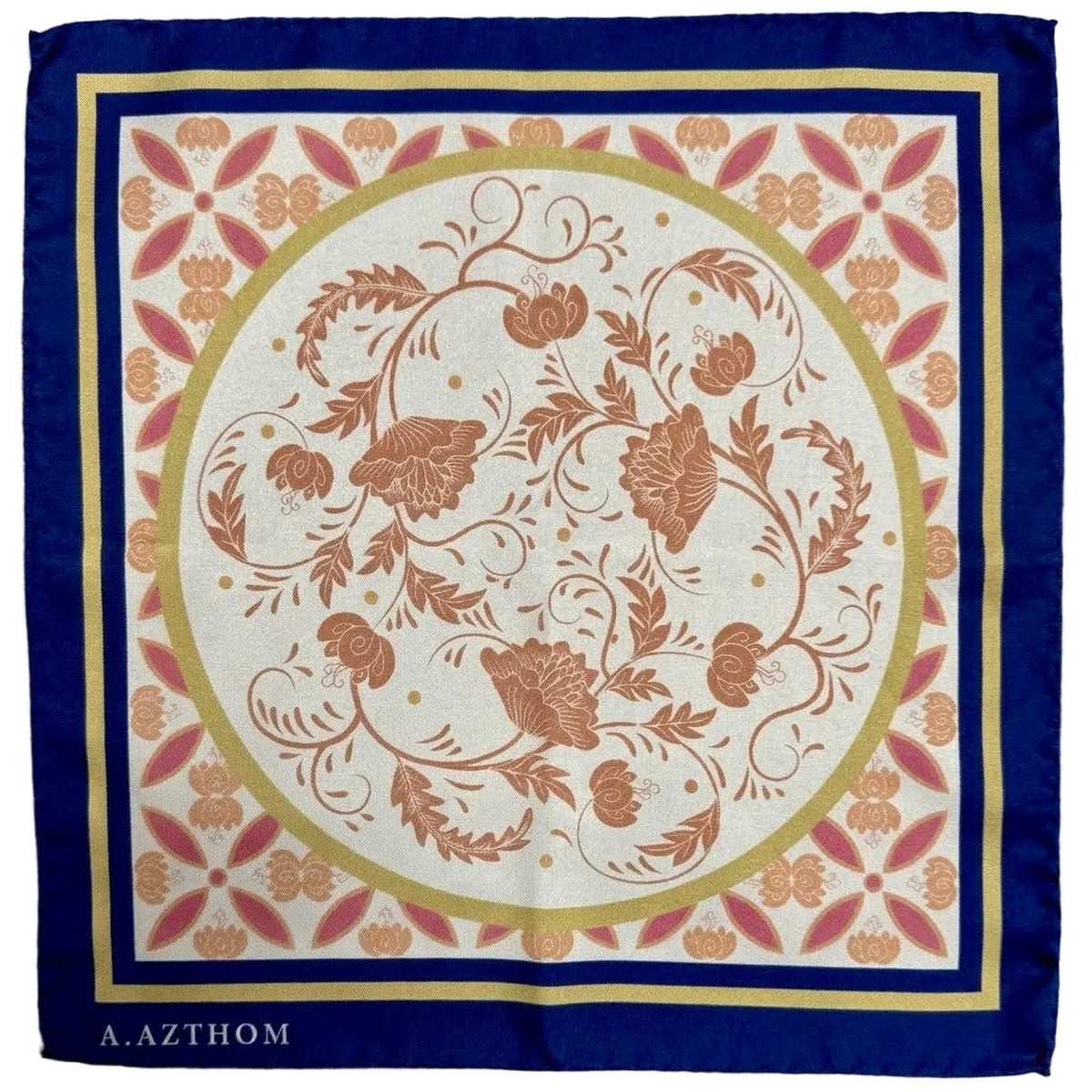 A square silk scarf with a traditional floral pattern, featuring a navy blue border, a gold inner border, and a central cream circle with terracotta-colored botanical motifs. The brand name 'A.
