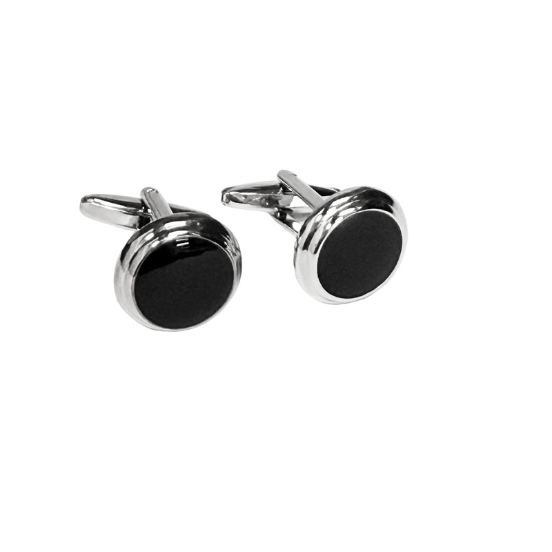 Pair of silver cufflinks with black circular stones on a white background