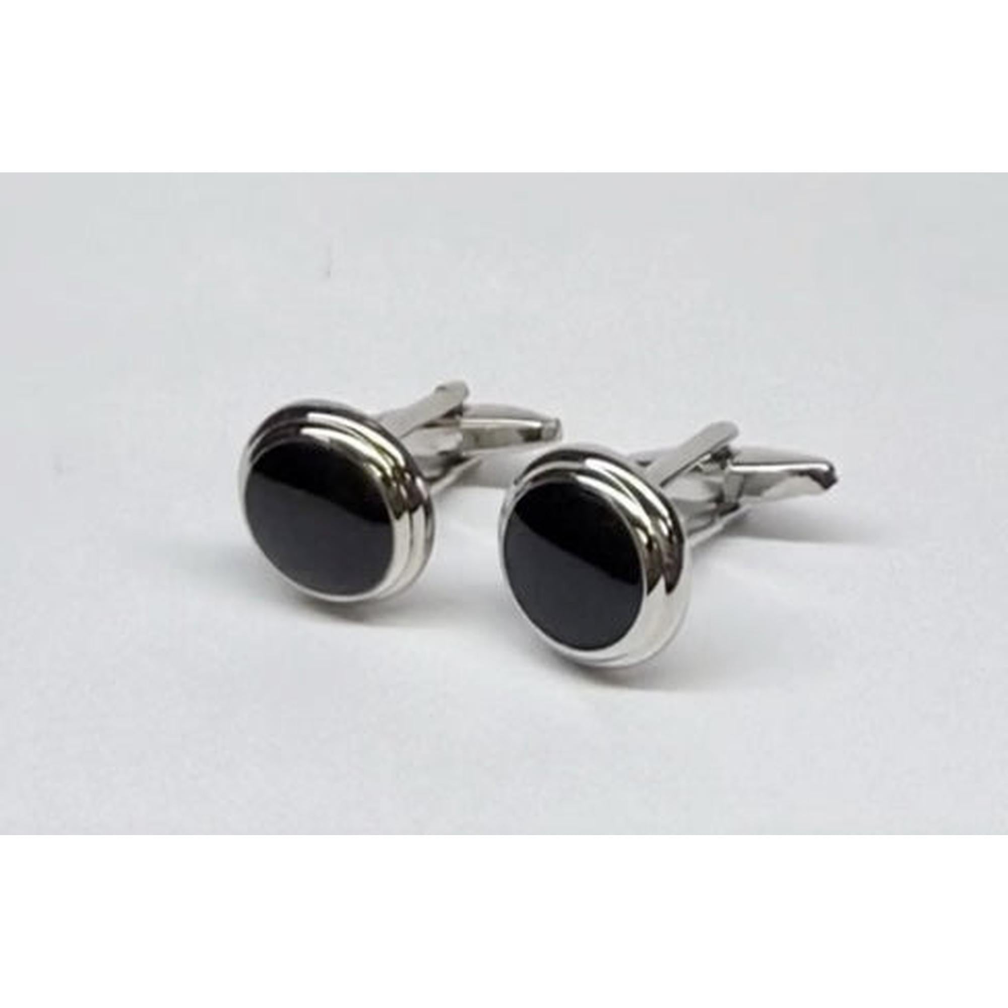 Pair of silver cufflinks with black stones on a light gray background