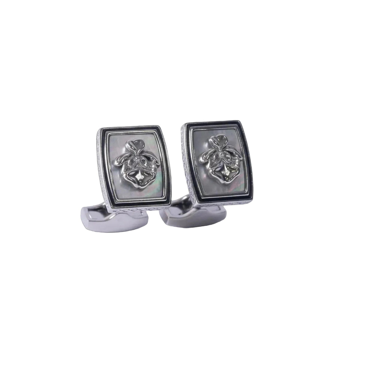 Pair of silver cufflinks with a detailed design on a white background